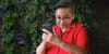 my head superimposed on an old lady's body who is looking at and holding a smartphone