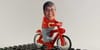 my head, smiling at the camera but superimposed on a stock photo of a Lego character on a bike